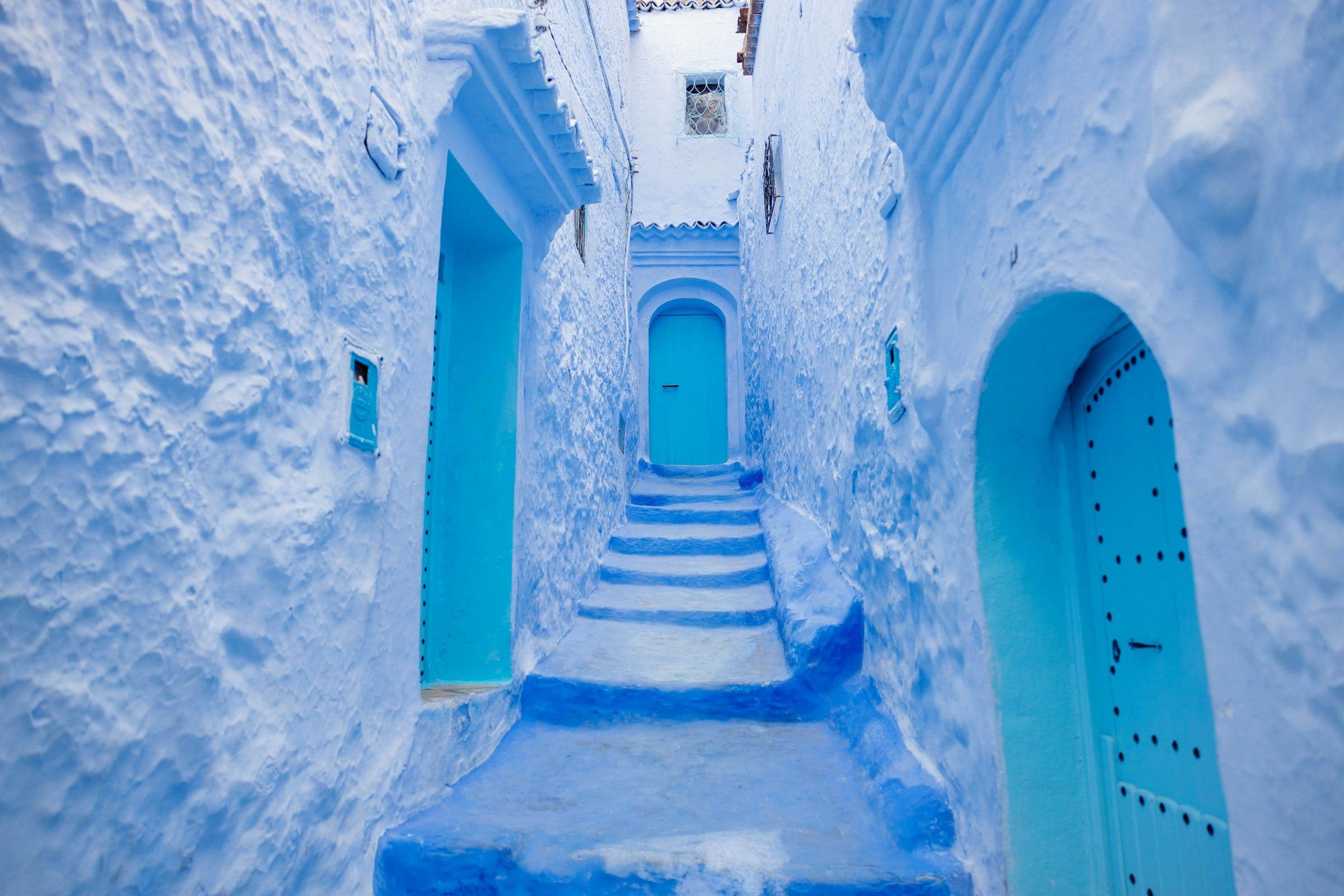 A powder-blue alley with turquoise doors in Chefchaouen